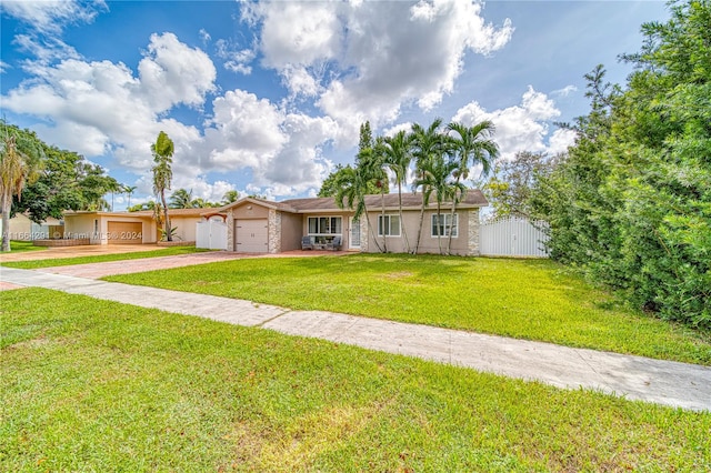 single story home featuring a garage and a front yard