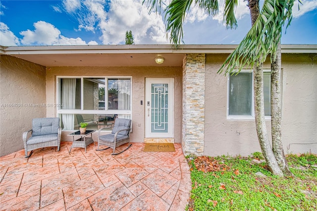 entrance to property featuring a patio area