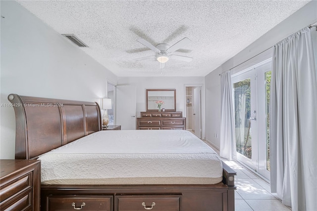 bedroom featuring a textured ceiling, access to outside, light tile patterned flooring, and ceiling fan