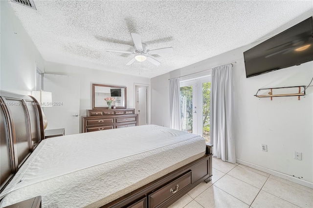 tiled bedroom featuring ceiling fan, a textured ceiling, and access to outside