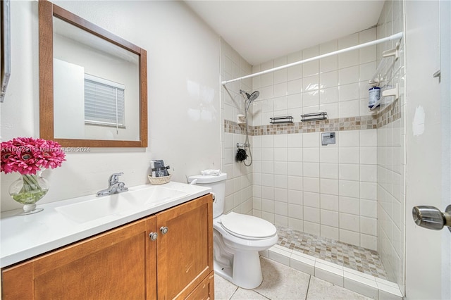 bathroom featuring tiled shower, vanity, toilet, and tile patterned floors