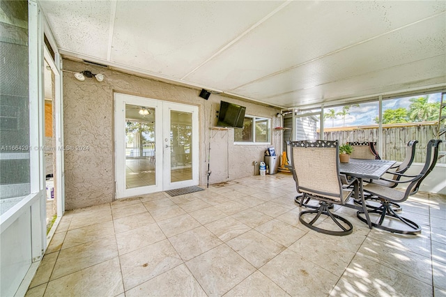 sunroom / solarium featuring french doors