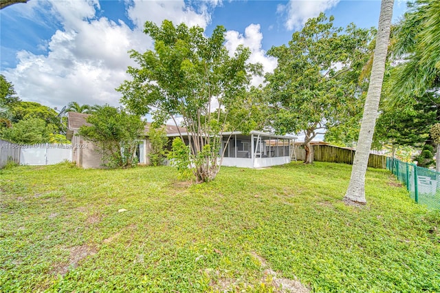 view of yard featuring a sunroom