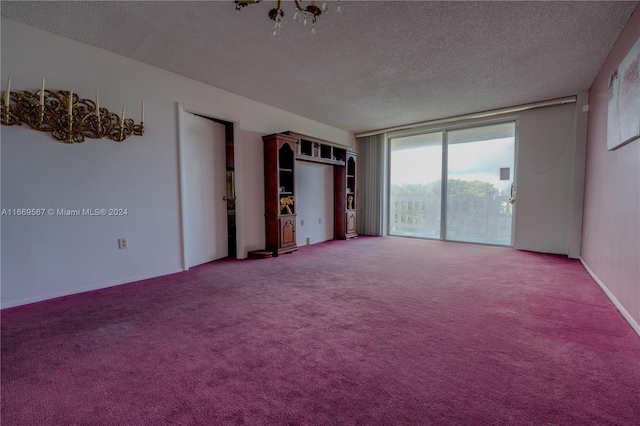 unfurnished room featuring a textured ceiling and carpet flooring