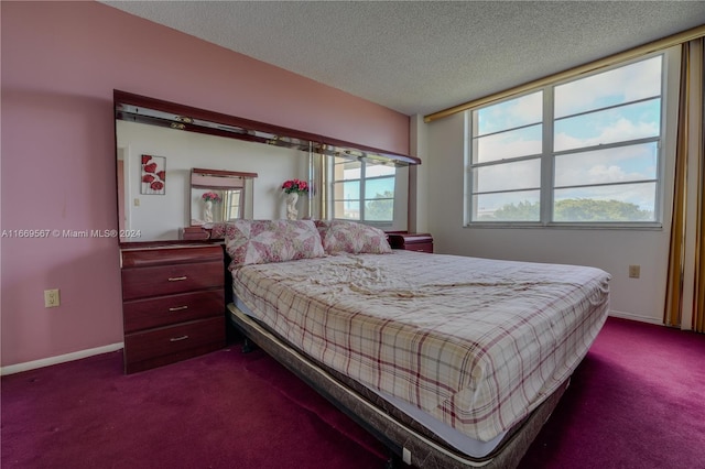 bedroom with dark carpet and a textured ceiling