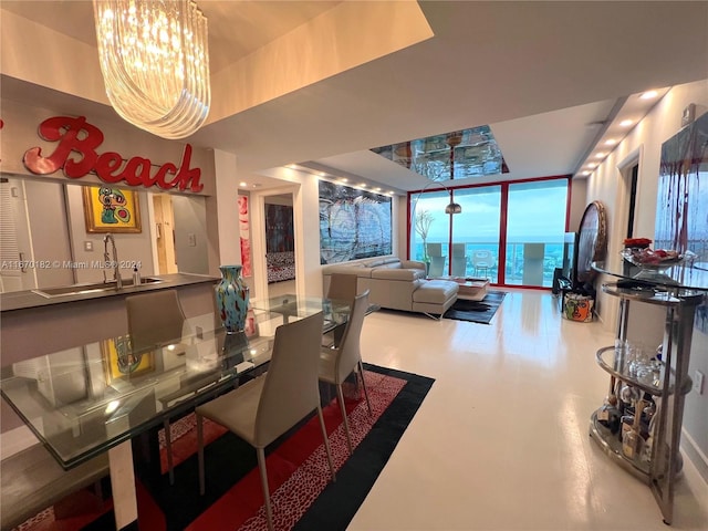 dining area featuring a notable chandelier and sink