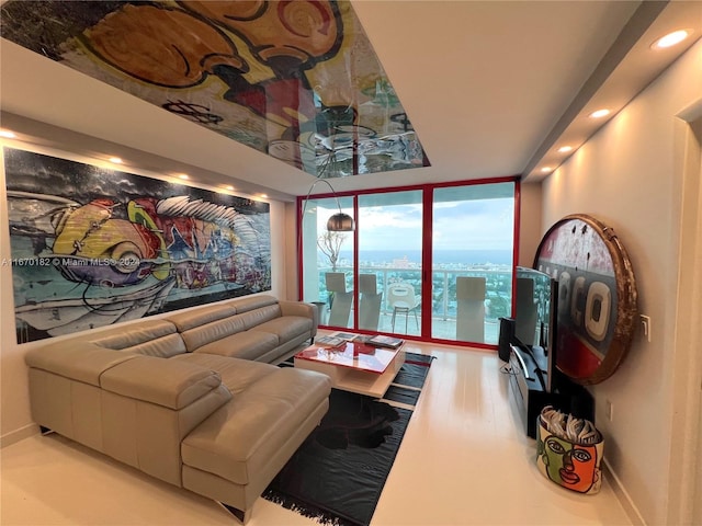 living room featuring light wood-type flooring and a wall of windows