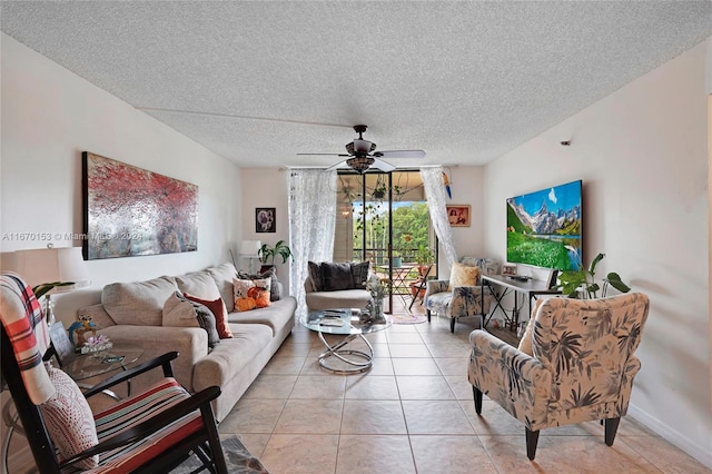 living room with ceiling fan, a textured ceiling, and light tile patterned floors