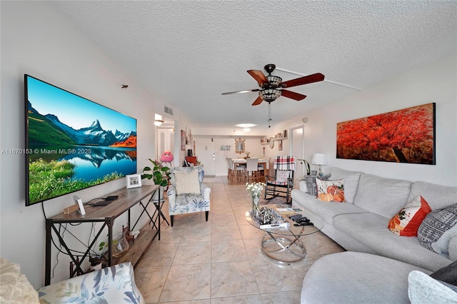 tiled bedroom featuring a textured ceiling and ceiling fan