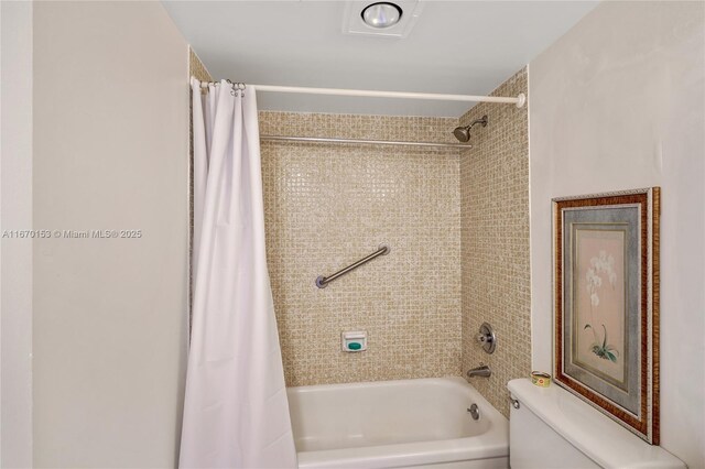 full bathroom featuring tiled shower / bath combo, vanity, and toilet