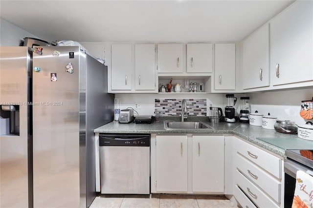 kitchen with white cabinets, appliances with stainless steel finishes, and sink