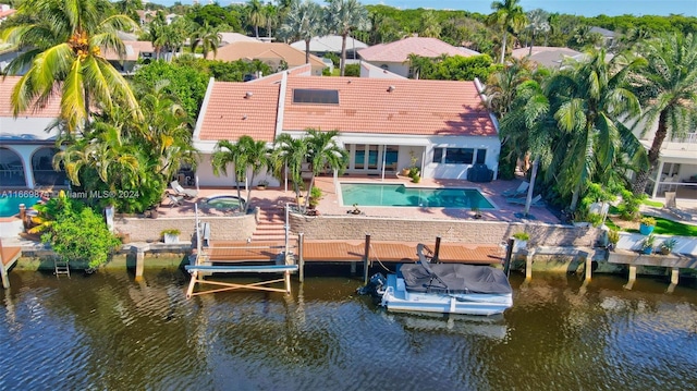 rear view of house with a water view and a patio area