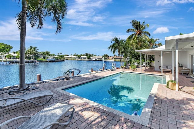 view of pool featuring a patio and a water view