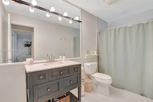 bathroom with vanity, tile patterned flooring, and toilet