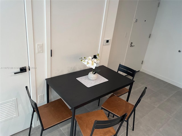 dining space featuring tile patterned flooring