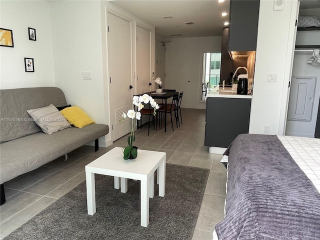 tiled living room featuring sink