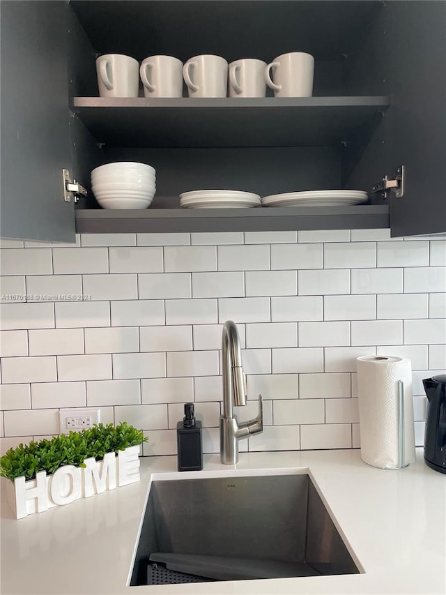 details featuring sink and tasteful backsplash