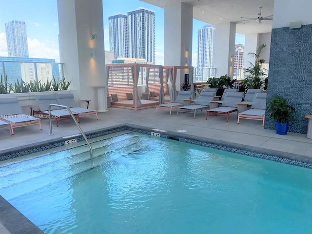 view of pool with ceiling fan and a patio area