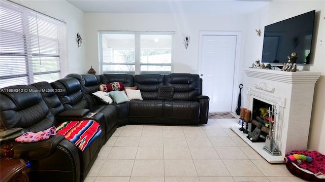 living room featuring a premium fireplace and light tile patterned flooring