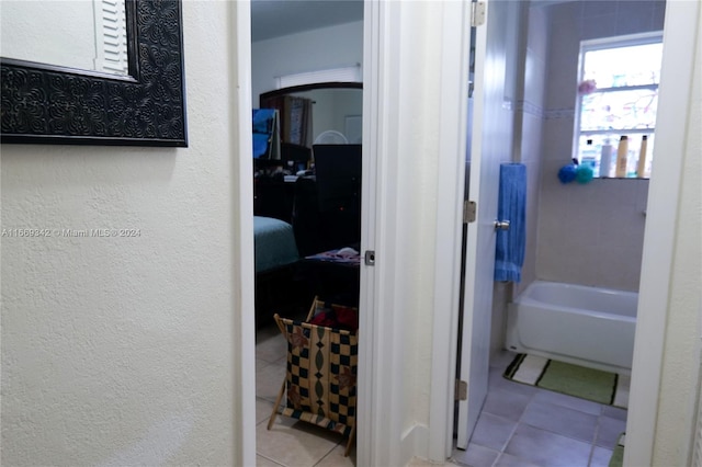 bathroom featuring a washtub and tile patterned floors