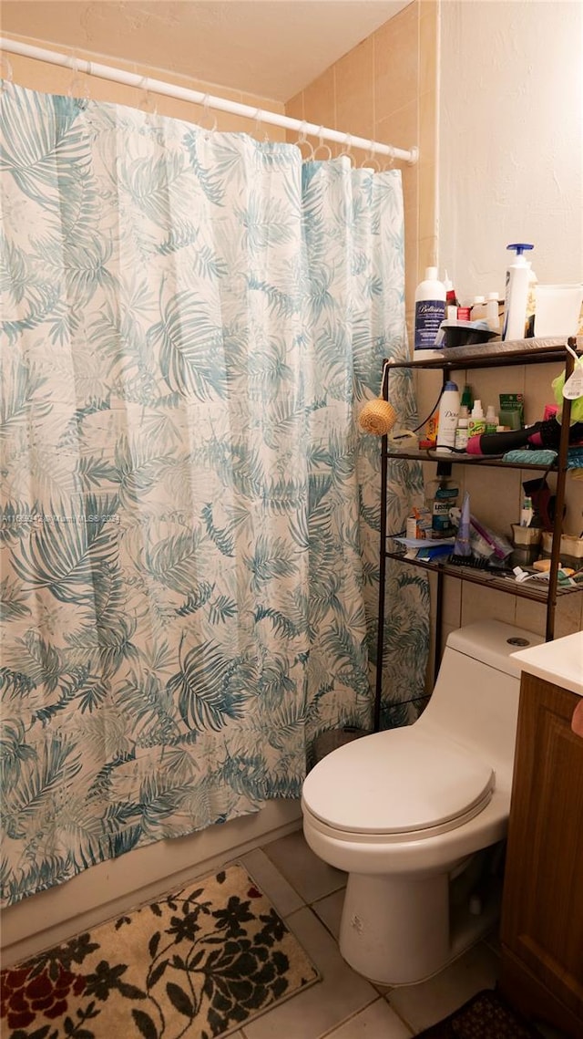 bathroom featuring tile patterned flooring, vanity, and toilet