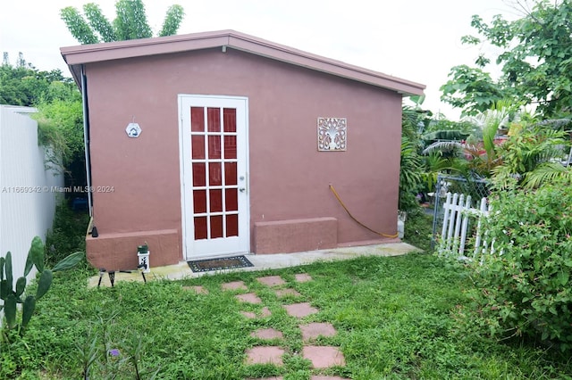 view of outbuilding with a yard