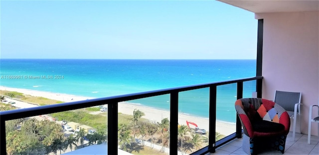 balcony featuring a beach view and a water view