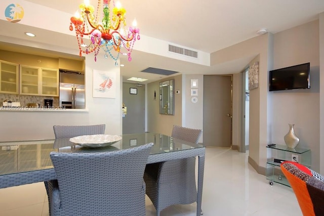 tiled dining space with a chandelier