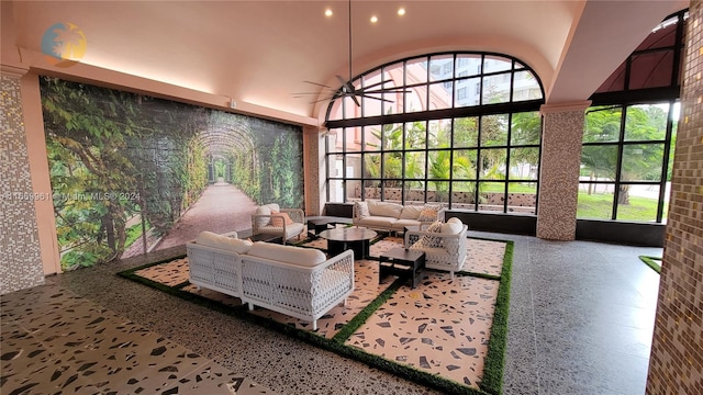 interior space with ceiling fan, a high ceiling, and recessed lighting