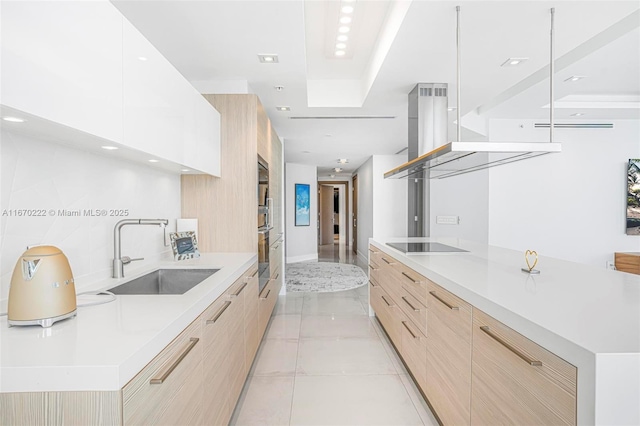 kitchen with black electric cooktop, sink, light brown cabinets, light tile patterned floors, and white cabinetry