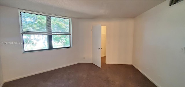 215 Lake Pointe Dr Unit 210, Oakland Park, FL 33309 - spare room featuring baseboards, dark carpet, and visible vents