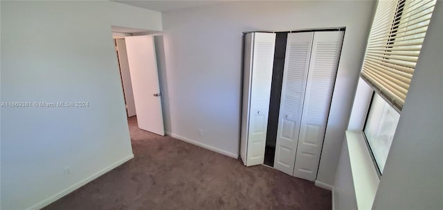 215 Lake Pointe Dr Unit 210, Oakland Park, FL 33309 - unfurnished bedroom with baseboards, a closet, and carpet