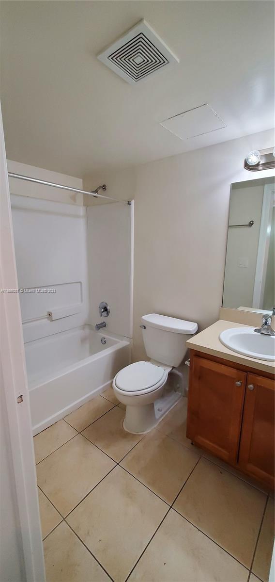 215 Lake Pointe Dr Unit 210, Oakland Park, FL 33309 - bathroom with vanity, toilet, tile patterned floors, visible vents, and shower / tub combination