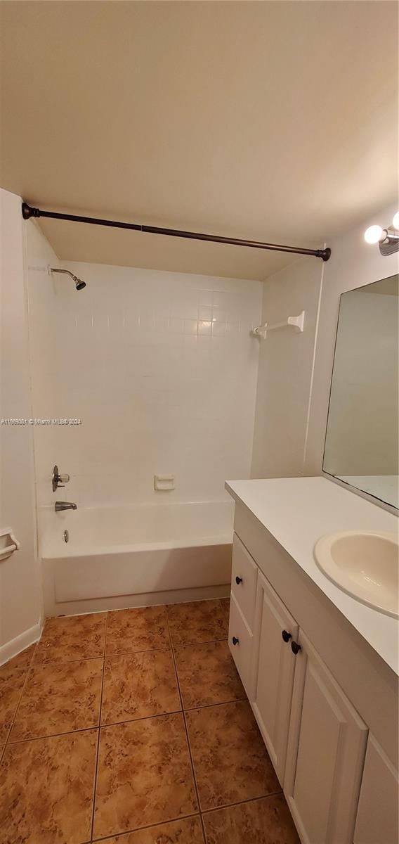 215 Lake Pointe Dr Unit 210, Oakland Park, FL 33309 - full bathroom with tile patterned floors, vanity, and shower / bath combination