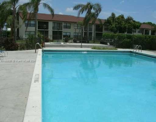 215 Lake Pointe Dr Unit 210, Oakland Park, FL 33309 - community pool featuring fence