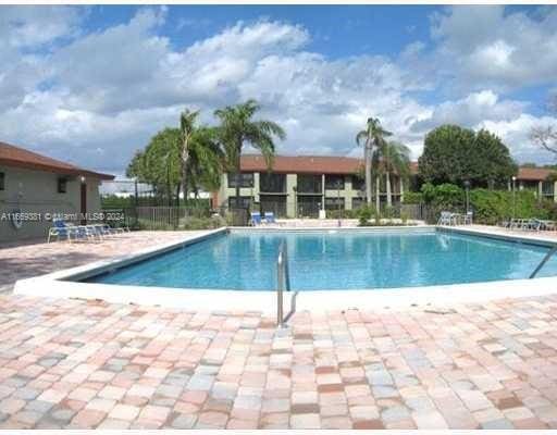 215 Lake Pointe Dr Unit 210, Oakland Park, FL 33309 - community pool featuring a patio and fence