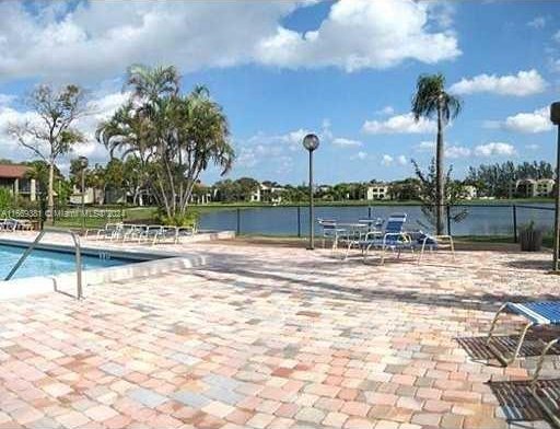 215 Lake Pointe Dr Unit 210, Oakland Park, FL 33309 - community pool with a water view, fence, and a patio