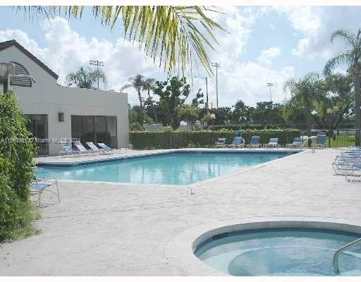 215 Lake Pointe Dr Unit 210, Oakland Park, FL 33309 - community pool with fence, a patio area, and a hot tub