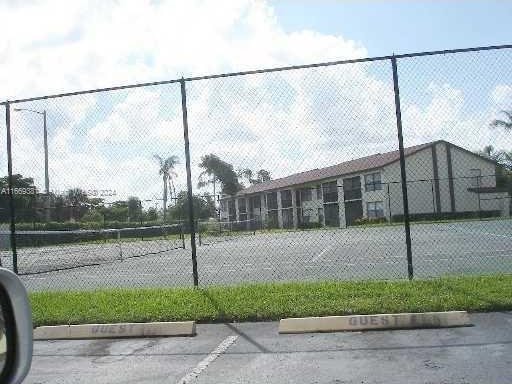 215 Lake Pointe Dr Unit 210, Oakland Park, FL 33309 - view of sport court featuring fence