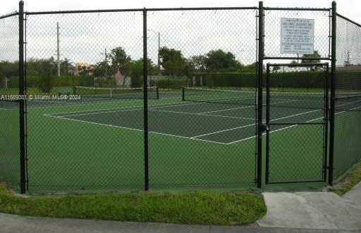 215 Lake Pointe Dr Unit 210, Oakland Park, FL 33309 - view of tennis court featuring fence