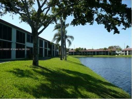215 Lake Pointe Dr Unit 210, Oakland Park, FL 33309 - view of home's community featuring a water view and a yard