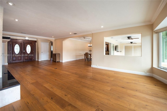 unfurnished living room with crown molding, hardwood / wood-style flooring, and ceiling fan