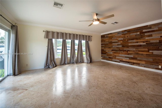 spare room with ceiling fan and ornamental molding