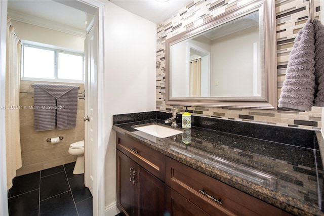 bathroom with vanity, tile walls, tile patterned floors, toilet, and backsplash