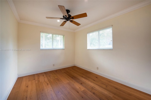 empty room with crown molding, light wood-type flooring, and ceiling fan