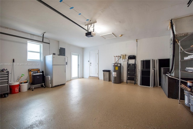 garage with white refrigerator, a garage door opener, and water heater