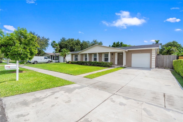 single story home with a garage and a front lawn