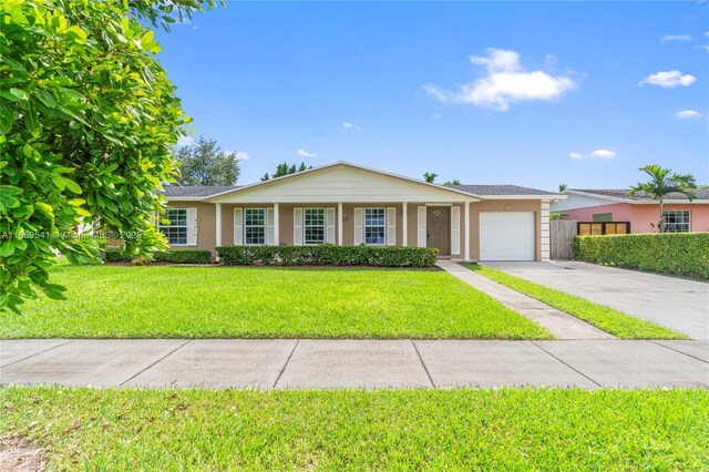 ranch-style house featuring a garage and a front yard