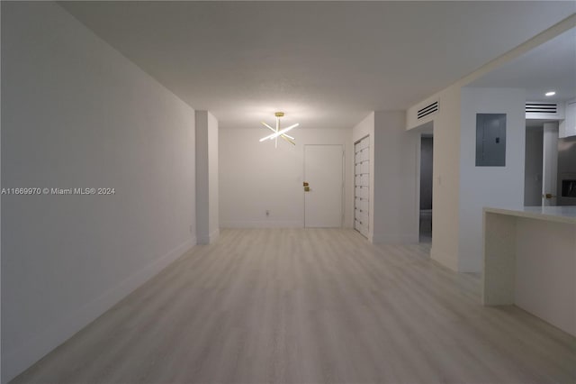 210 172nd St Unit 332, Sunny Isles Beach, FL 33160 - empty room featuring electric panel, a chandelier, and light wood-style flooring