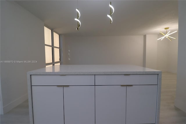 bathroom with wood-type flooring and a chandelier